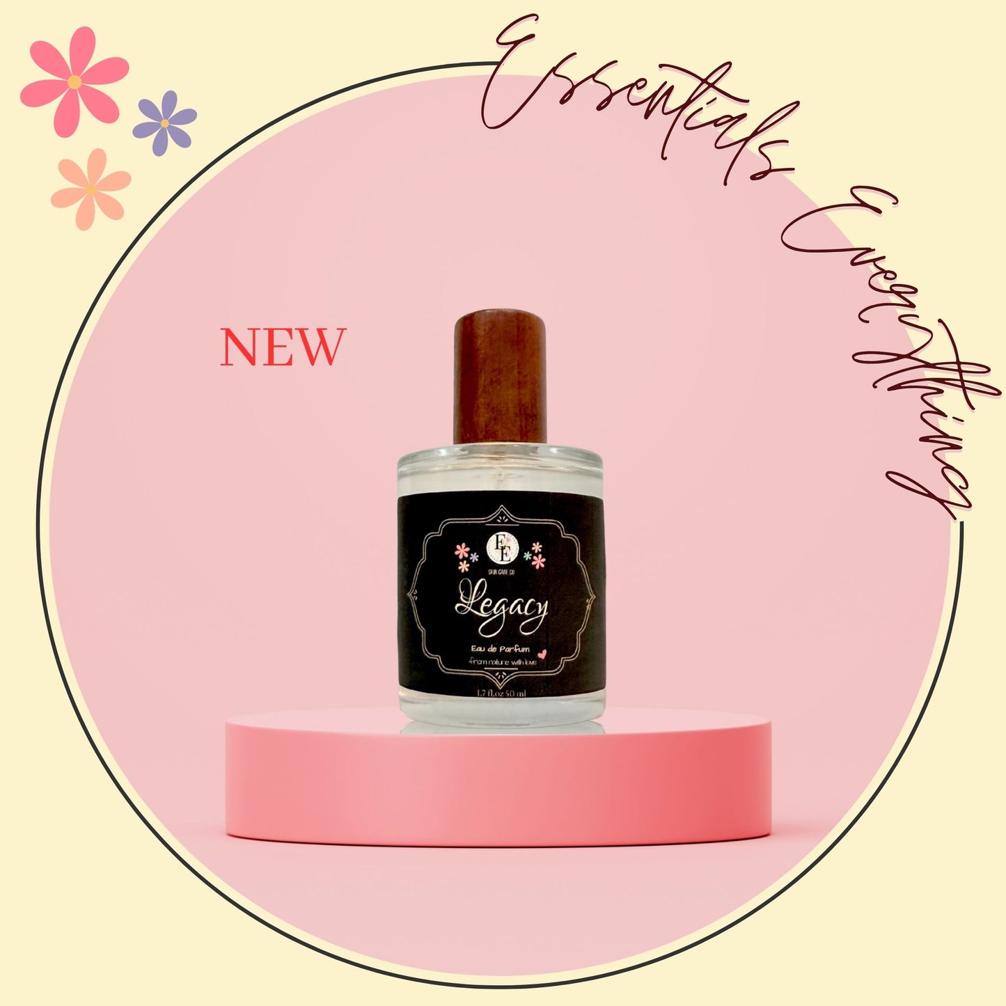 A bottle of Legacy by 4 Essential Oils diffuser oil with a dark brown wooden cap and a black label, displayed on a pink pedestal against a light pink circular background with decorative text and flowers.